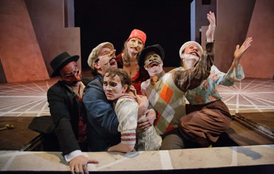 The Faction of Fools cast for Hamlecchino, with arms extended and mouths a-woeing in Opehlia's grave, a trap door on the stage